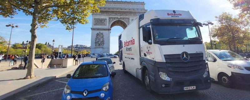 A Britannia truck drives past the Arc de Triomphe in Paris during Removals to France