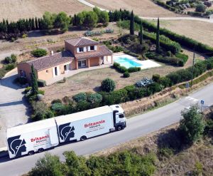 A Britannia Robbins truck carrying out a removal to Italy, with a large truck arriving at a villa with a swimming pool